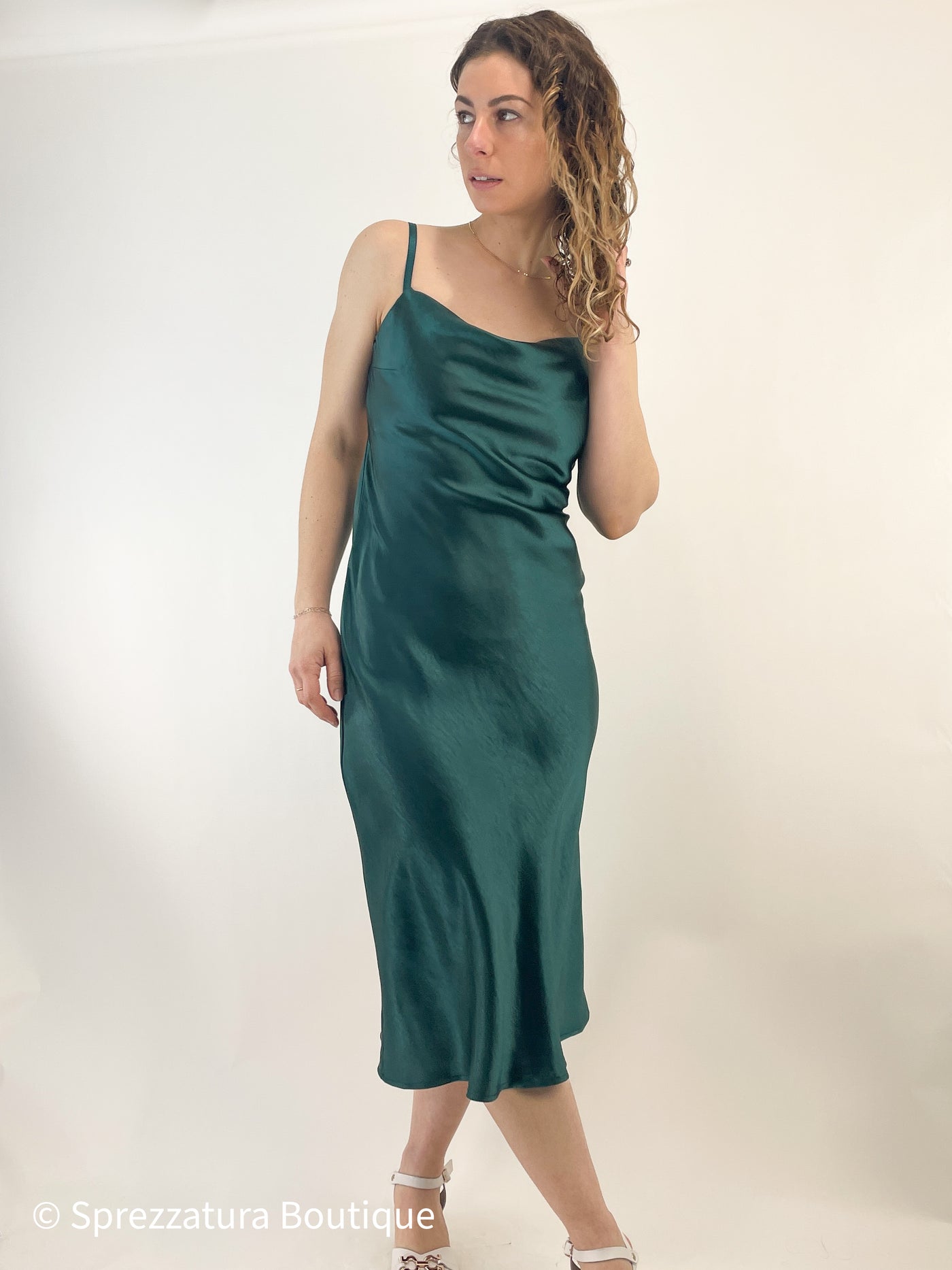 satin slip dress with open criss cross back and cowl neck front. emerald green chic perfect for any special event or wedding. midi length satin adjustable straps