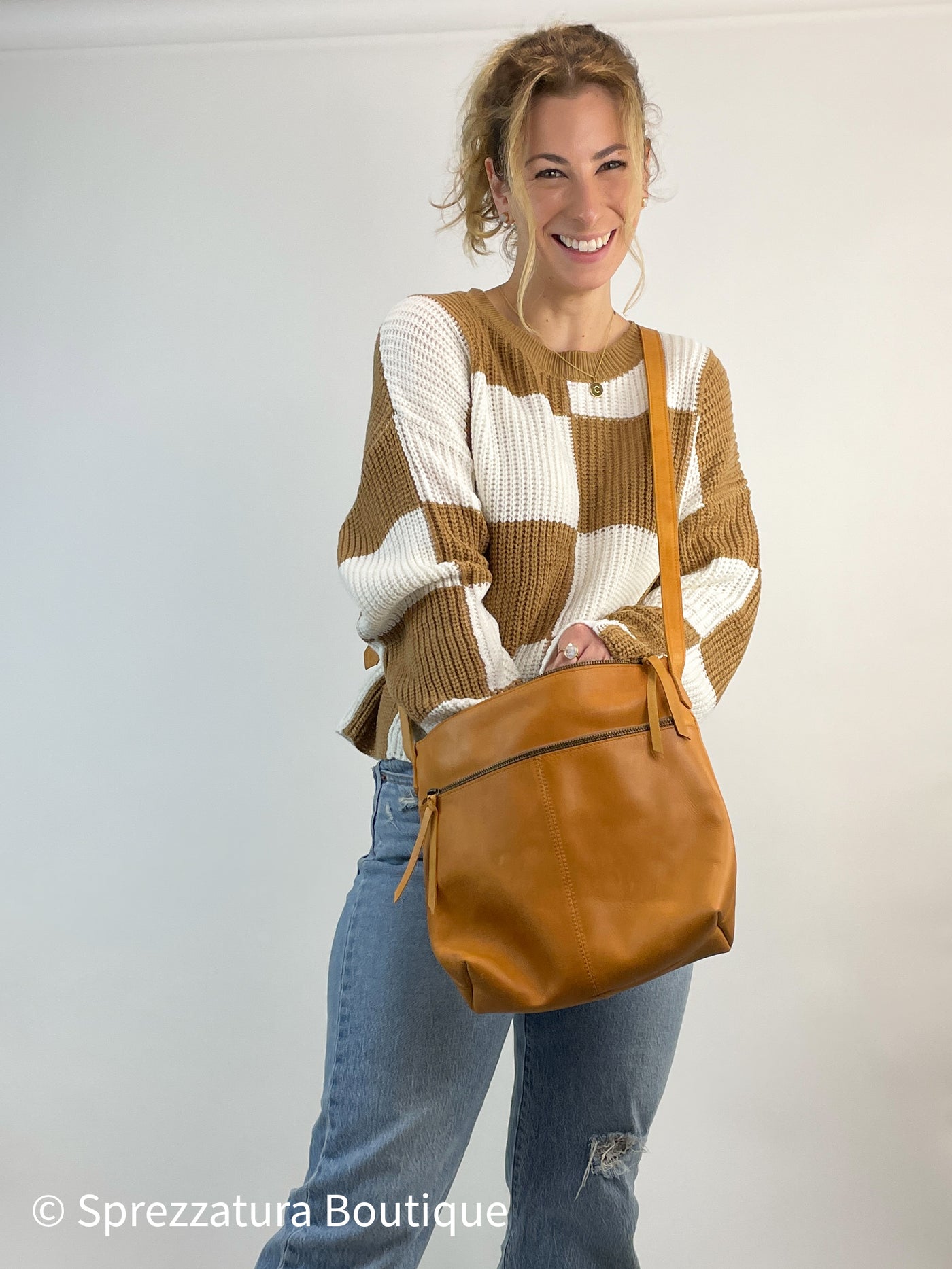Cognac tan leather purse made by women paid a living wage ethical working conditions sustainable chic stylish timeless classic zipper crossbody purse empowering women. Modern smart causal female chic effortless outfit womens ladies gift elegant effortless clothing clothes apparel outfits chic summer style women’s boutique trendy fall back to school teacher office cute outfit  lounge athleisure midsize curvy sizes