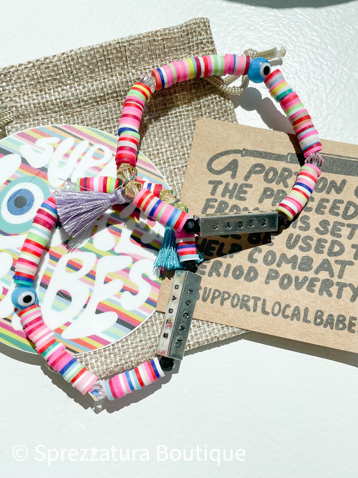 Colorful heishe beads evil eye bracelet handmade locally made support local babes tassel. period poverty donation support woman made