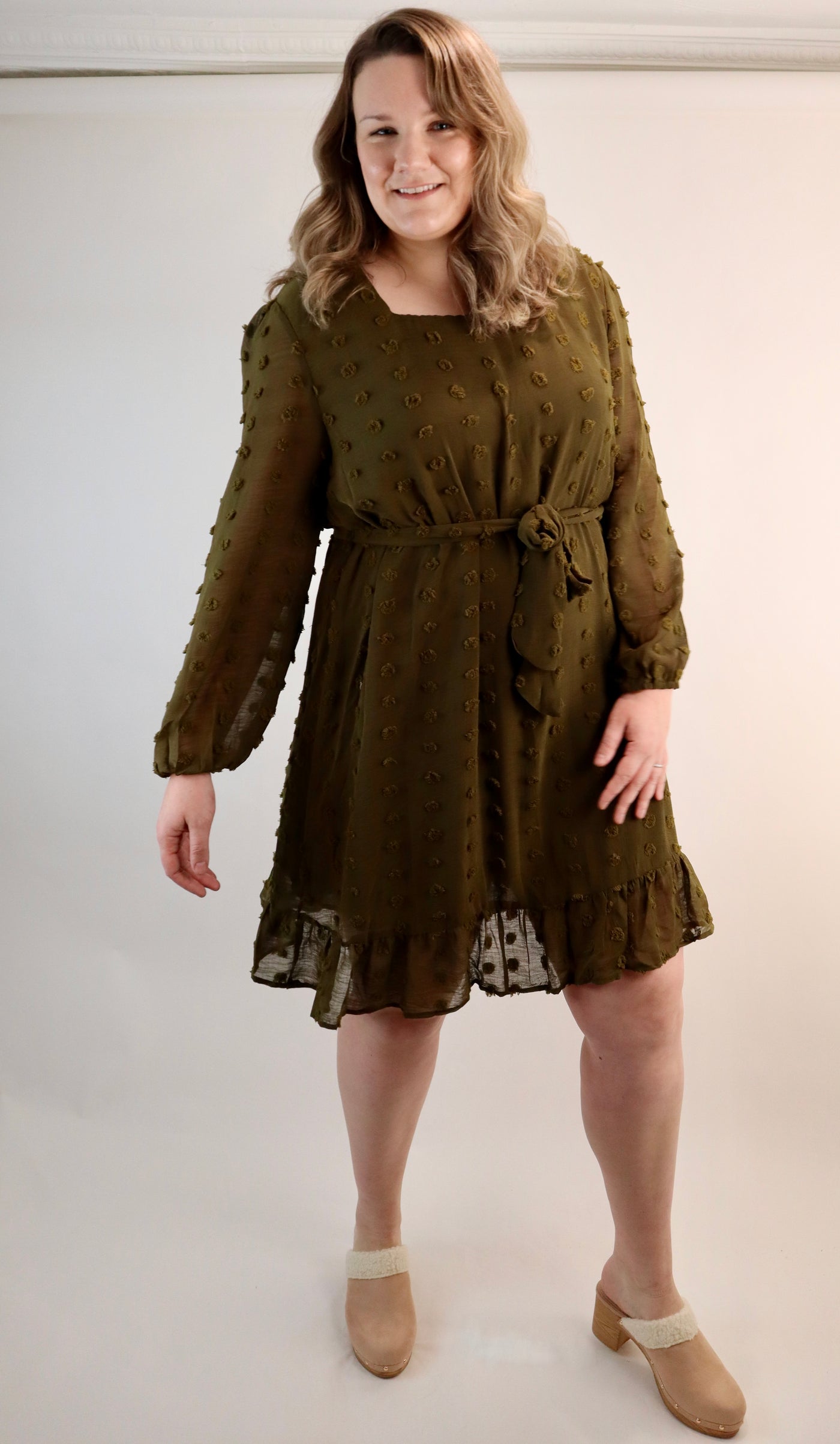 Olive green dress that hits and knee with textured polka dots all over. Square neckline with sheer sleeves that is for curvy sizes. Plus size dress with juggle bottom and tie waist.
