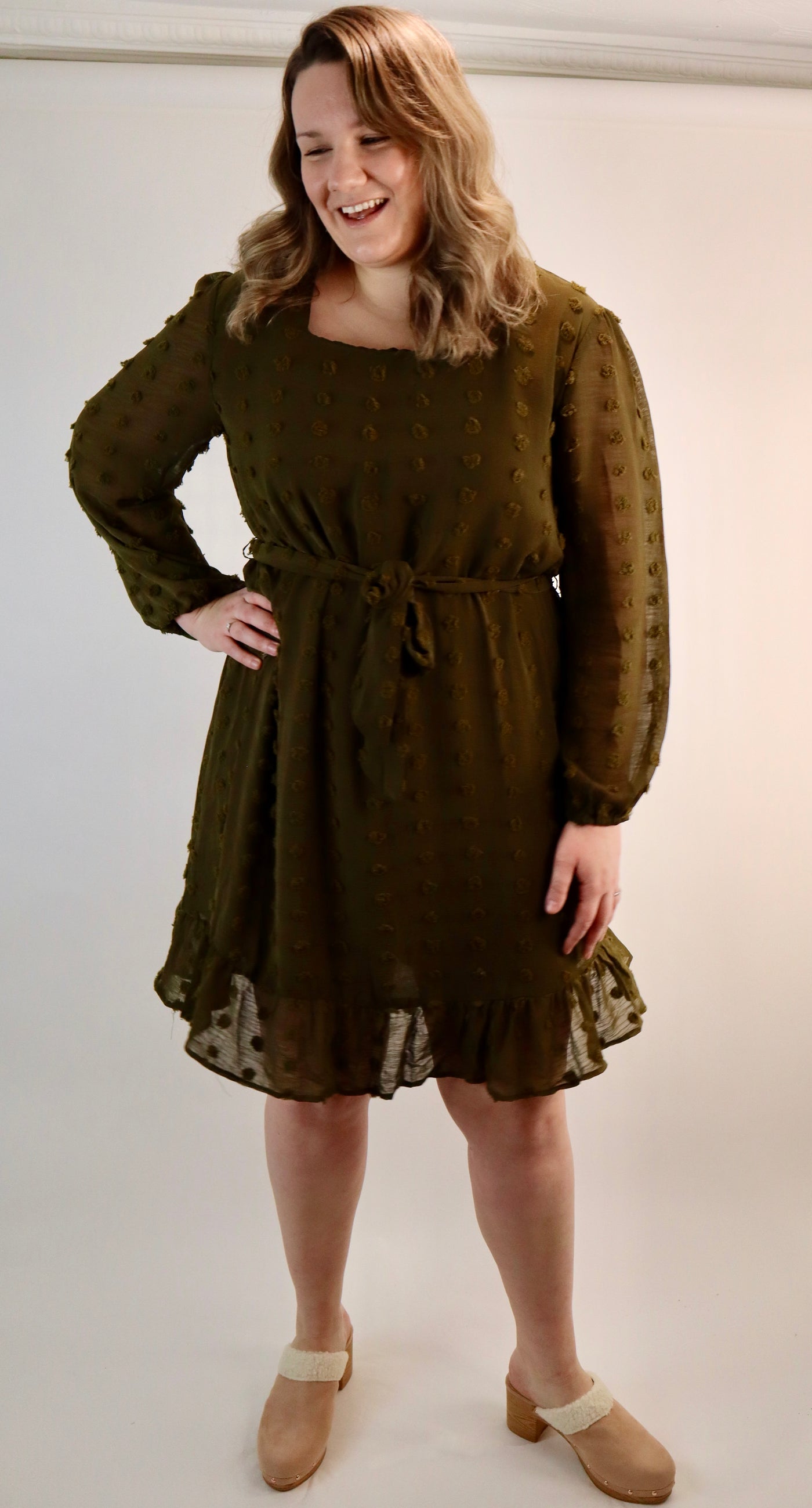 Olive green dress that hits and knee with textured polka dots all over. Square neckline with sheer sleeves that is for curvy sizes. Plus size dress with juggle bottom and tie waist.