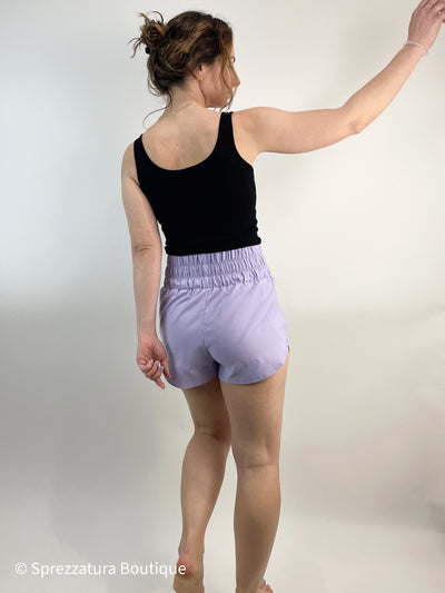 Lilac track shorts. Lightweight super high rise women's shorts for exercise or athleisure casual shorts. Elastic waistband comfortable shorts in lavender. Pastel purple shorts