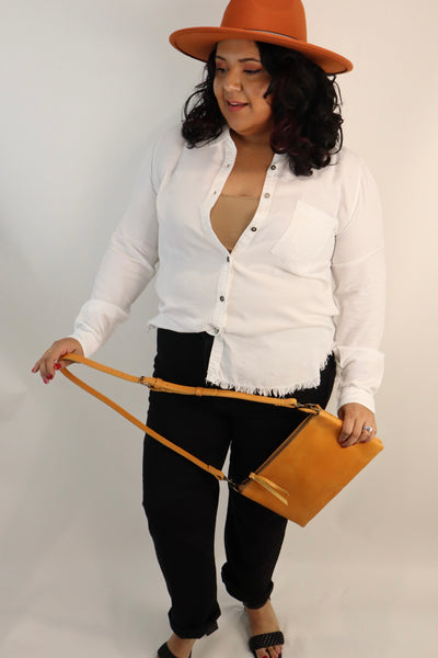 High quality leather crossbody purse made by hand by women that are paid a living wage. Cognac colored purse in buttery leather. Lots of pockets and detachable shoulder strap makes it great for traveling.