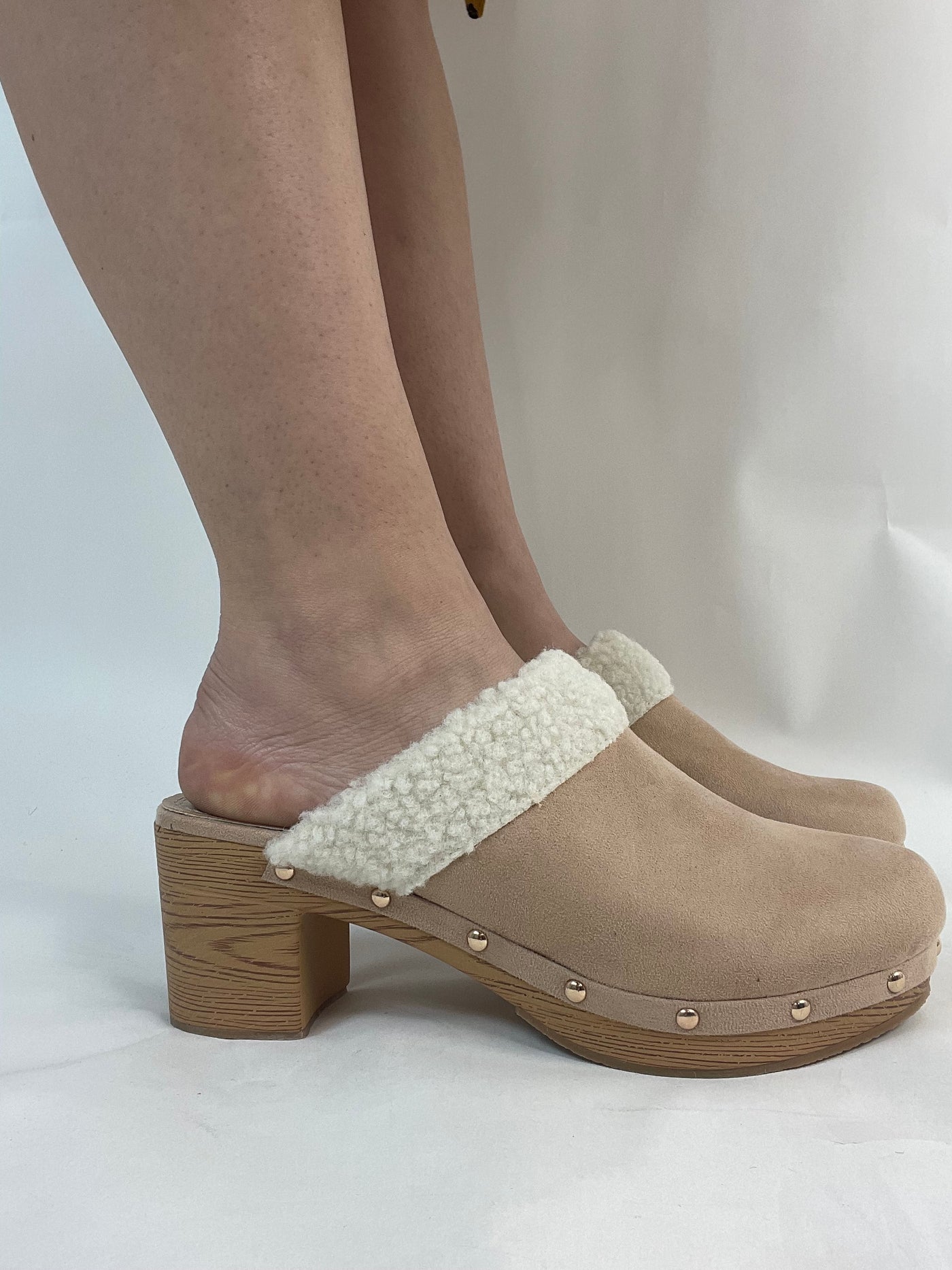 Nude pink faux suede and faux fur clogs.