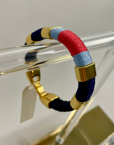 Navy, coral, sky blue make up the pattern of this handmade rope bracelet with gold metallic accents and clasp to create a classic New England coastal bracelet.