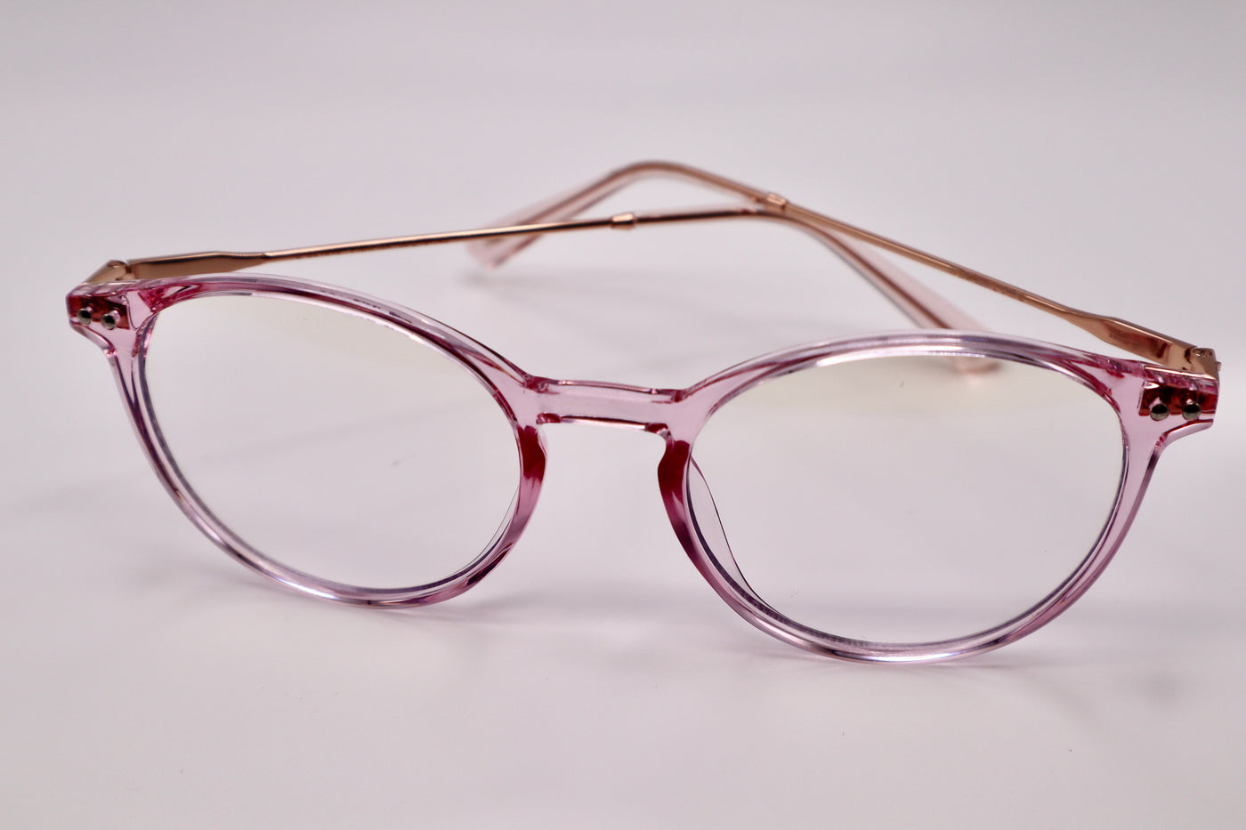 Pink translucent framed blue light blocking glasses. Round frame women's glasses