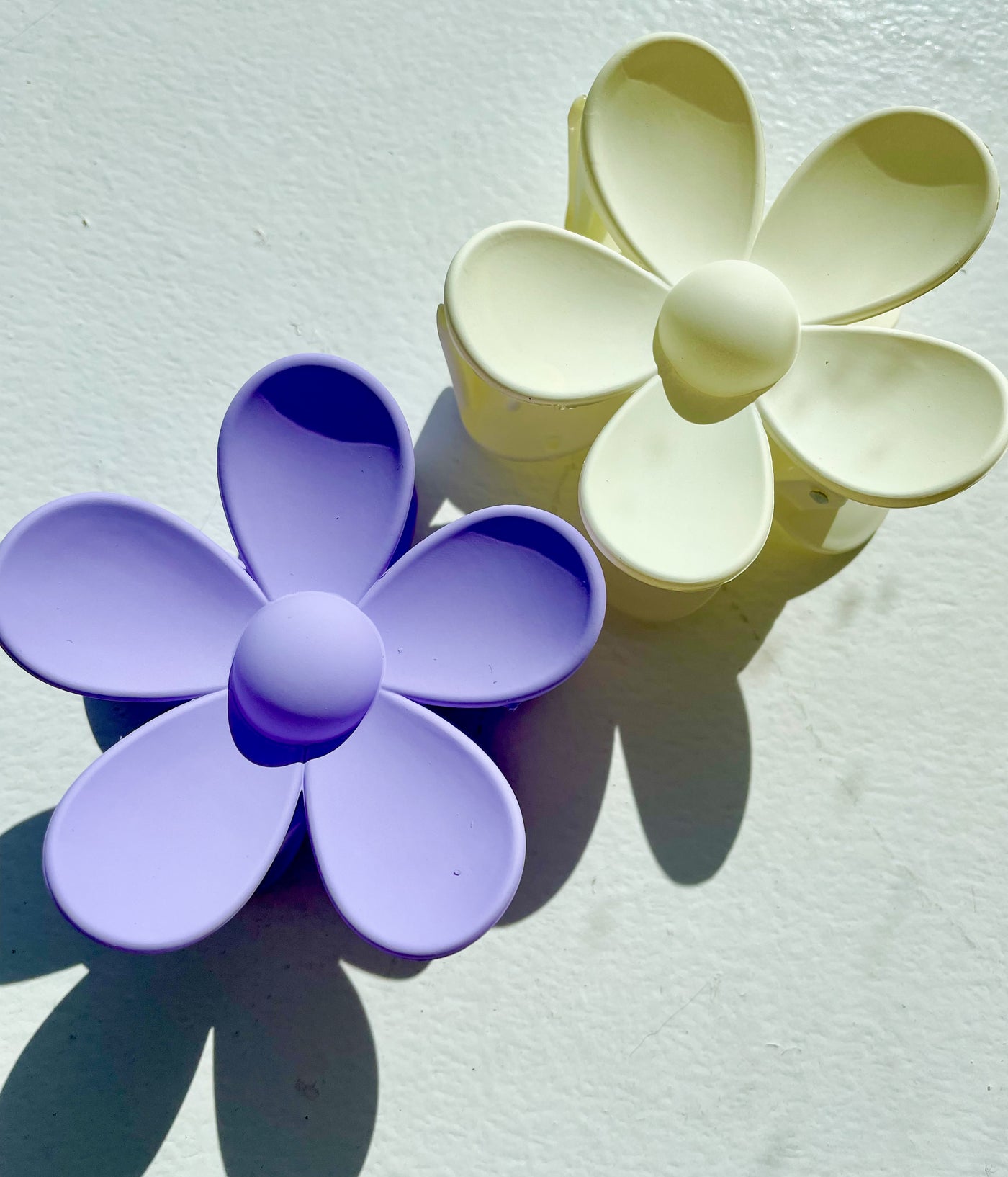 Large 3 inch powder coated flower shaped hair clips in white and periwinkle/ purple.